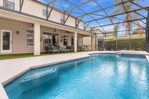 a swimming pool in the backyard of a house at Hidden gem! Gorgeous villa next to Disney in Kissimmee