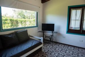a living room with a couch and a window at Casa Isabela in Santa Clara del Mar