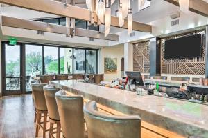 a bar with chairs and a television in a restaurant at Pet-Friendly Scottsdale Vacation Home with Patio in Scottsdale