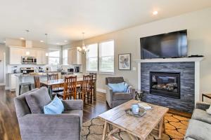 a living room with a fireplace and a dining room at Ocean Shores House with Hot Tub - Walk to Beach in Ocean Shores