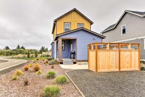 a house with a wooden fence in front of it at Ocean Shores House with Hot Tub - Walk to Beach in Ocean Shores