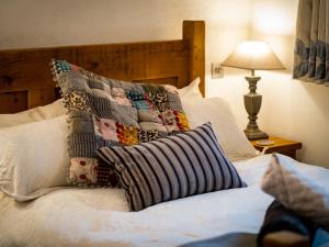 a bedroom with a bed with a pillow on it at Grayrigg Foot Stable in Grayrigg