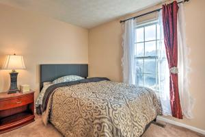 a bedroom with a bed and a window at Burtonsville Townhome 20 Mi to DC! in Burtonsville