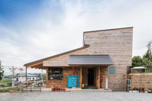 a small building with a black roof at Family Hotel Matsumoto Satoyama Doors in Matsumoto
