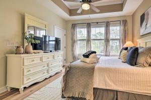 a bedroom with a large bed with a flat screen tv at Updated Barefoot Resort Condo On-Site Golf! in North Myrtle Beach