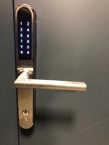 a door handle with a cell phone on it at Apartimento Hydral Lusso in Wrocław