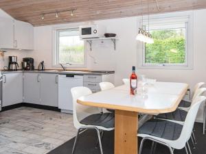 a kitchen and dining room with a table and chairs at Holiday home Sydals LXXVII in Sønderby