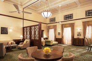 a large living room with a couch and a table at Umaid Bhawan Palace Jodhpur in Jodhpur