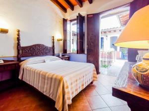 a bedroom with a bed and a large window at Meson del Alferez Xalapa in Xalapa