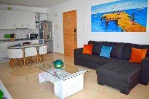 a living room with a couch and a table at Taninho in Santa Maria