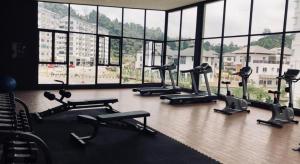 a gym with several treadmills and a large window at The Misty Penthouse in Tanah Rata