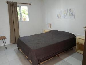 1 dormitorio con cama y ventana en Departamento El Nogal en Villa Santa Cruz del Lago