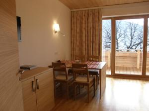 a kitchen with a table and chairs and a window at Apartments Karlhof in Innsbruck