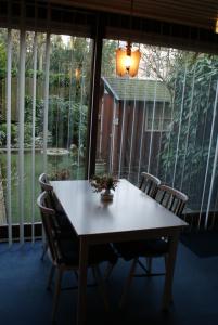 a table and chairs in front of a large window at Hotel Domstad in Utrecht