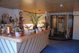 a salon with a counter with flowers on it at Hotel Domstad in Utrecht