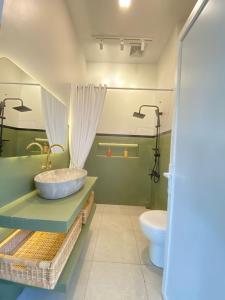 a bathroom with a sink and a toilet at Karabineri Private Pool Jogja Villa in Ngaglik