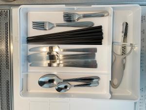 a drawer filled with silver utensils in a drawer at PRISM Inn Komagata Asakusa in Tokyo