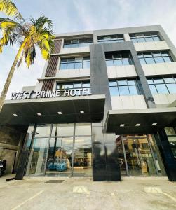 een gebouw met een palmboom ervoor bij West Prime Hotel in Calbayog