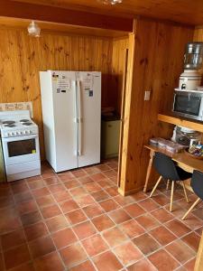 a kitchen with a white refrigerator and a stove at Bott's Beach Retreat - Maslin Beach - 100M to beach in Maslin Beach