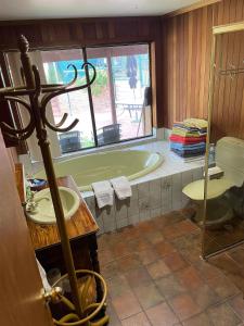 a bathroom with a bath tub and a sink at Bott's Beach Retreat - Maslin Beach - 100M to beach in Maslin Beach