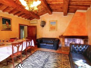 a living room with a table and a fireplace at Belvilla by OYO Villa Valardegna in Montepulciano