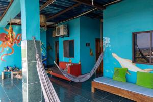 a room with a hammock and a room with blue walls at Mango Tree in San Cristóbal