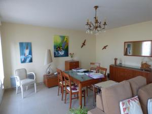 sala de estar con mesa de comedor y sofá en Maison Jullouville, 4 pièces, 6 personnes - FR-1-361-149, en Jullouville-les-Pins