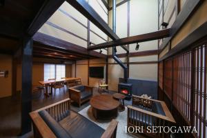 a large room with a table and a fireplace at IORI Stay HIDA in Hida