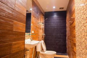 a bathroom with a toilet and a sink at The Main Event in Pattaya South