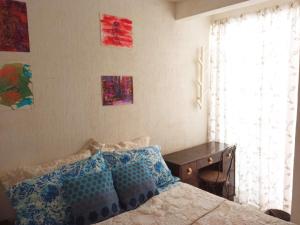 a bedroom with a bed and a desk and a window at Rooftop Paradise Central Location, Scenic Views in Mexico City