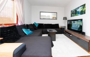 a living room with a couch and a flat screen tv at Nice Home In Velika With Outdoor Swimming Pool in Velika