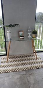 a table with a potted plant on top of a rug at Cozy Stays Cayala Apartments 602 in Guatemala