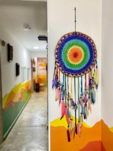 a colorful dream catcher hanging on a wall in a hallway at Hotel Anauco in Bucaramanga
