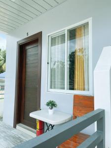 a white table on the porch of a house at Casa D’ Hiyas Homestay Panglao, Bohol in Panglao