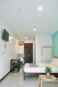a room with a bed and a tv in it at Casa D’ Hiyas Homestay Panglao, Bohol in Panglao