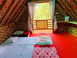 a bed in the middle of a room in a tent at Argapuri Jungle Resort Ciwidey in Ciwidey