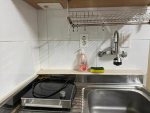 a kitchen counter with a sink and a sink at Sangmin suite in Daejeon