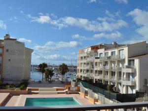 a view from the balcony of a apartment building with a swimming pool at Appartement Cap d'Agde, 2 pièces, 6 personnes - FR-1-249-127 in Cap d'Agde