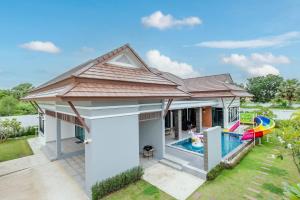 a home with a pool and a house with a roof at Aora Pool Villa Huahin in Ban Bo Fai (1)