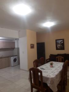 a dining room with a table and chairs and a kitchen at Apartamentos Naomi 1B in El Carmen