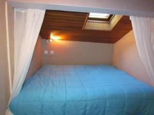 コトレにあるAppartement Cauterets, 1 pièce, 4 personnes - FR-1-401-45の青いベッドが備わる屋根付きのベッドルーム1室が備わります。