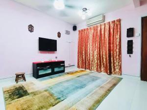 a living room with a large rug on the floor at Izzara Iskandar Puteri Homestay Gelang Patah in Gelang Patah
