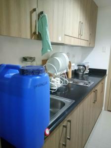 a kitchen counter with a sink and a blue bin at Shore Residences Tower D (Condo Unit ShoreWorknPlay) in Manila