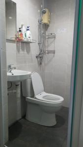 a bathroom with a toilet and a sink at Haising Hotel in Singapore +14 photos