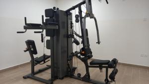 a gym with several tread machines in a room at Harmony Park, East Cantonments, Accra in Accra