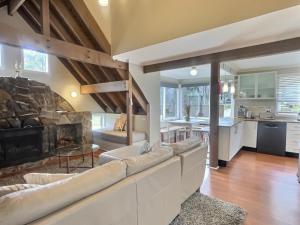 a living room with a couch and a fireplace at Meltdown, alpine-getaways in Dinner Plain