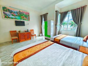 a hotel room with two beds and a television at Thuy Thanh Hotel in Con Dao