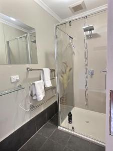 a bathroom with a shower and a glass shower stall at Meltdown, alpine-getaways in Dinner Plain