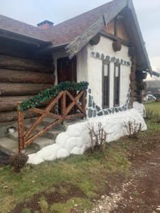 a log cabin with a porch and a door at Popas Regal 