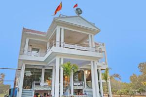 a white building with two flags on top of it at RD Palace and Resort in Lucknow